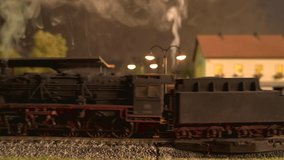 Toy steam locomotive arriving at train station. - Powered by Shutterstock - Get 15% off with code: PIKWIZARD15