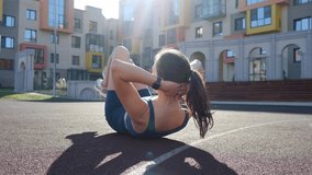 Young sports girl performs an exercise on the press. Warm up before exercising. Beautiful athletic body. Bodyweight training - Powered by Shutterstock - Get 15% off with code: PIKWIZARD15