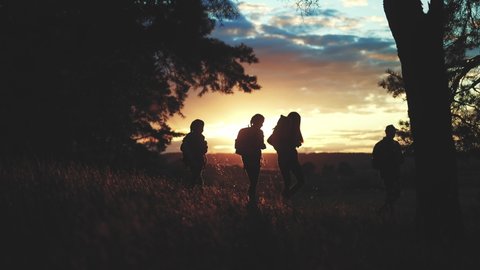 hiker group. team of hikers with backpacks silhouette walk through the forest. nature travel a adventure concept. hiker lifestyle group with backpacks walk on the sunset. mountain outdoor view