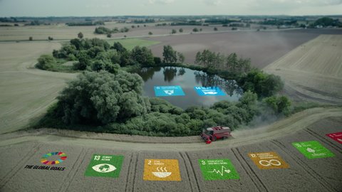 Ecological Green Energy The Global Goals Icons Concept Drone Shot of Harvester In a Cornfield