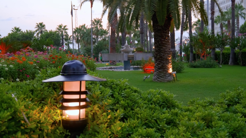 In the evening a lantern is burning in the bushes