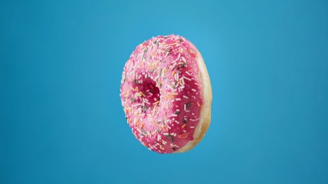 Donuts of different colors changing at blue background. Stop motion of rotating donuts. Glazed sweet desserts. Bakery and food concept. Various colorful donuts. Chocolate, pink, blue donuts in 4K, UHD