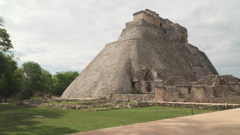 UXMAL, MEXICO - CIRCA 2021: Timelapse video of the Pyramid of the Magician, a step pyramid and central landmark of ancient Mayan city of Uxmal, Yucatan