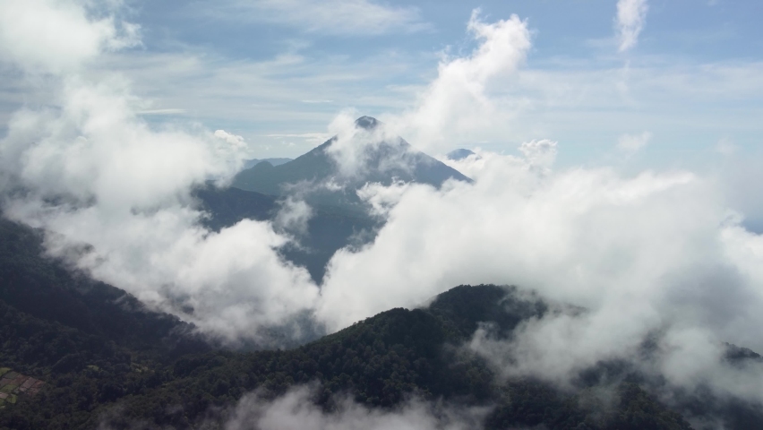 Aerial view of Santa Maria volcano, flying through the smoke puffed out by Santiaguito volcano, near Quetzaltenango (Xela), Guatemala Royalty-Free Stock Footage #1079037809
