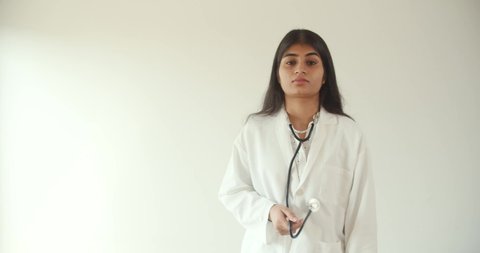 A 4K footage of an Indian woman doctor looking cheeky and talking to the camera