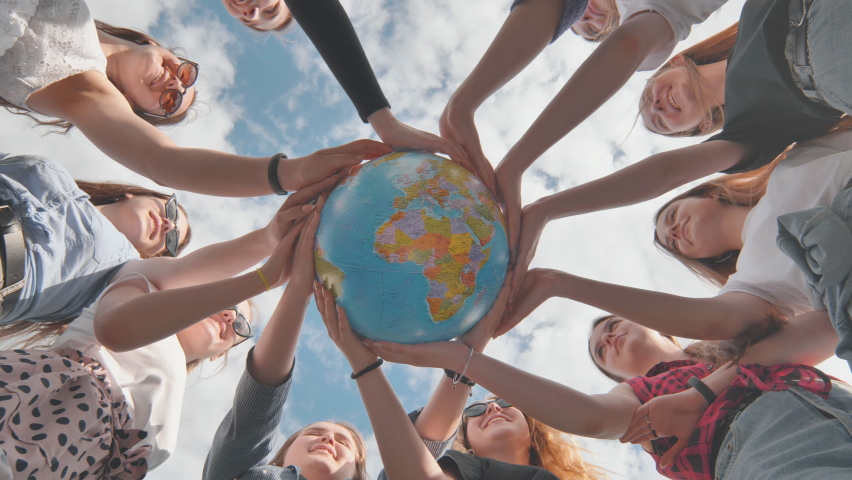Earth conservation concept. 11 girls hug the earth globe with their hands. Royalty-Free Stock Footage #1079052140