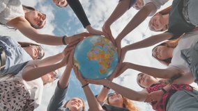 Earth conservation concept. 11 girls hug the earth globe with their hands. - Powered by Shutterstock - Get 15% off with code: PIKWIZARD15