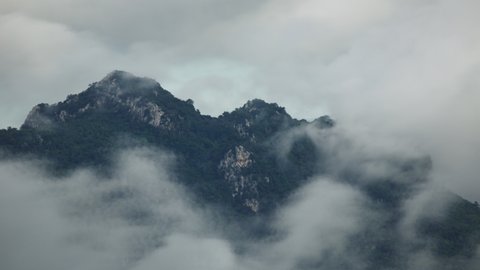 Time lapse, Beautiful Landscape in the morning time during sunrise with fog above the mountain, White fluffy clouds moving softly on cloudy, Pang puai Mae moh Lampang, Thailand.