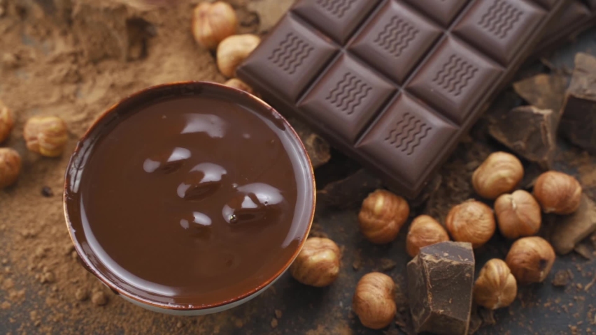 Hazelnuts Falling in Milk Chocolate. recipe For making chocolate with nuts. Cooking handmade chocolate bar, dessert, candies. Confectionery Royalty-Free Stock Footage #1079062295