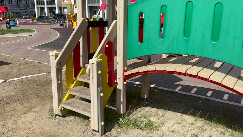 Wooden safe colorful constructions with stairs, fences and slides in the playground