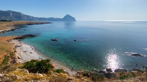 Shooting of Macari and the Bue Marino beach near San Vito Lo Capo in Sicily in the summer. Sun and sea in Sicily. Cliff overlooking the blue and crystalline sea.