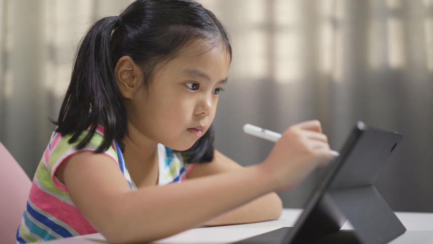 closeup asian child student study online or kid girl enjoy write or art drawing learning on computer tablet screen by touch pen with doing homework or people back to school by learn from home on pad Royalty-Free Stock Footage #1079070659