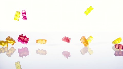 Jelly baby or Gummy Bears falling against White Background, Slow Motion, 1000fps. High-quality 4k footage