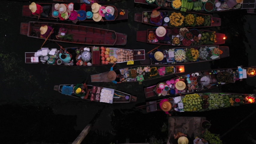 Top view from drone of famous and unique floating market at Damnoen Saduak early in the morning. Plenty of fresh fruits, vegetables, flowers and street food available to buy.  | Shutterstock HD Video #1079072066