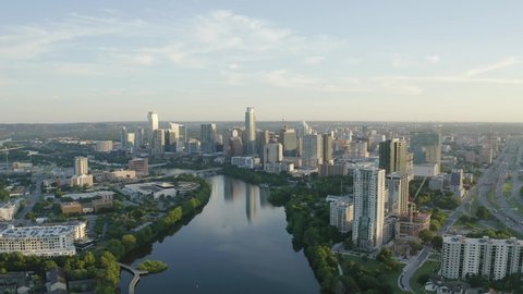 Panoramic view of downtown Austin, Texas skyline landscape with Lady Bird Lake and Colorado River in the foreground - 4K Drone