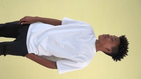 Vertical video of young African American teenager portrait middle shot on clear background in studio . - Powered by Shutterstock - Get 15% off with code: PIKWIZARD15