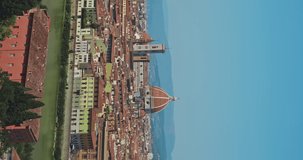 Vertical video of Florence at sunset. Watching the beautiful ancient european city with its narrow streets, buildings and monuments from the viewpoint. Enjoying the cityscape and having good time.