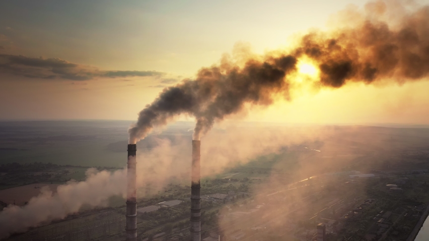Aerial view of coal power plant high pipes with black smoke moving up polluting atmosphere at sunset Royalty-Free Stock Footage #1079082737