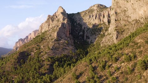 Aerial view of the Cabezo D'Or mountain. A granite summit with spectacular cliffs and rock strata, in Alicante, Spain.