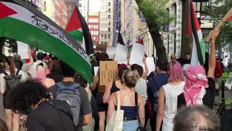 NYC, USA - SEPT 12, 2021: Palestinian rights demonstration march - protestors marching outside NYU in New York City.