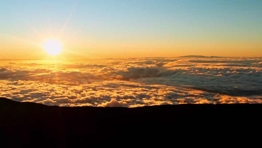 Mauna Kea Observatory view to the sunset over the clouds 