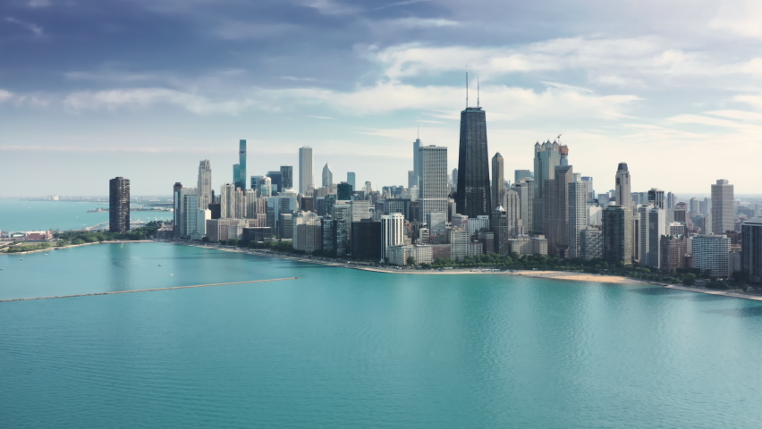 Amazing clear and vibrant blue waters of Michigan lake in Illinois with breathtaking Chicago downtown cityscape on background. Cinematic aerial Chicago coastline on sunny summer day with copy space Royalty-Free Stock Footage #1079090615