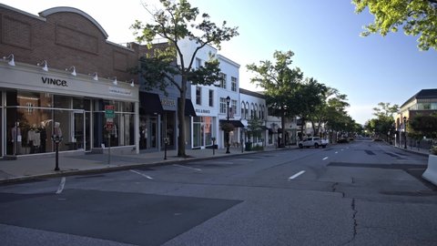 GREENWICH, CT, USA - SEPTEMBER 11, 2021:  Storefronts with morning lights at Greenwich Avenue
