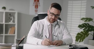 Doctor is making a prescription for patient. Professional healthcare service worker talking to a patient - online medicine, health and safety 4k footage