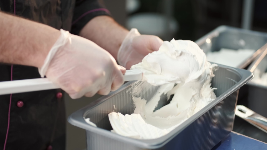 Man making gelato ice cream in professional kitchen