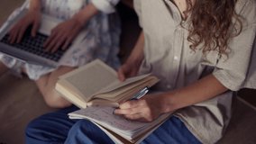 Female students learning together in university library on the floor, high angle - Powered by Shutterstock - Get 15% off with code: PIKWIZARD15