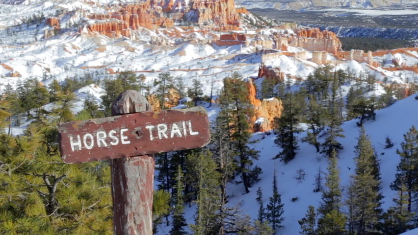 Horse trail sign post in Bryce Canyon National Park in Winter covered with snow