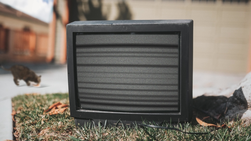 Old TV Outside Interference Screen Static Noise Zoom Out. Vintage television broadcasting static noise interference left on the street. zoom out