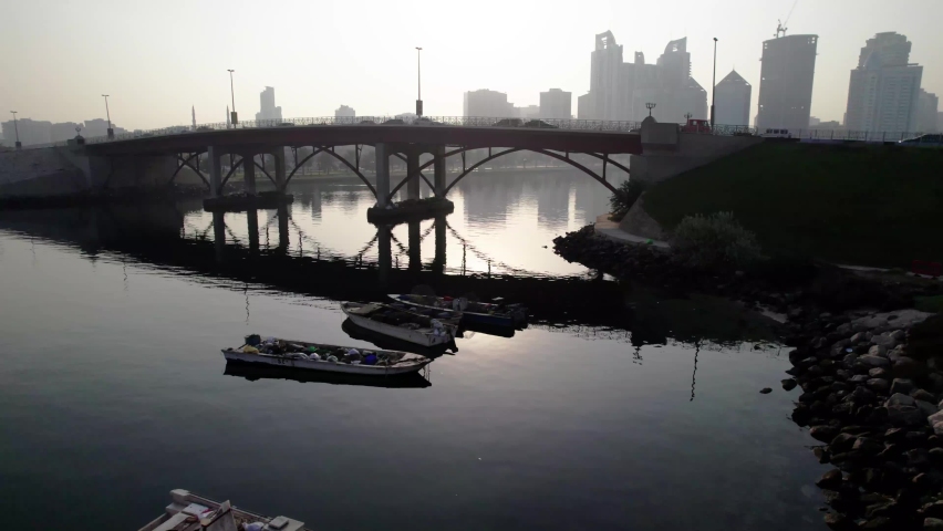 An aerial pan across Khalid lake in Sharjah shows the silhouette of sharjah skyline