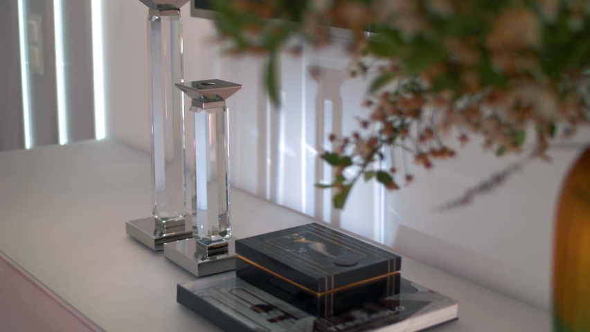 Play of light and shadows in a modern lacquer interior in a light style with houseplants. Close-up 