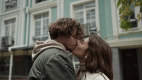 Portrait of love couple kissing on city street. Affectionate man circling woman in arms outdoor in slow motion. Young lovers feeling happy during romantic date on urban background. - Powered by Shutterstock - Get 15% off with code: PIKWIZARD15