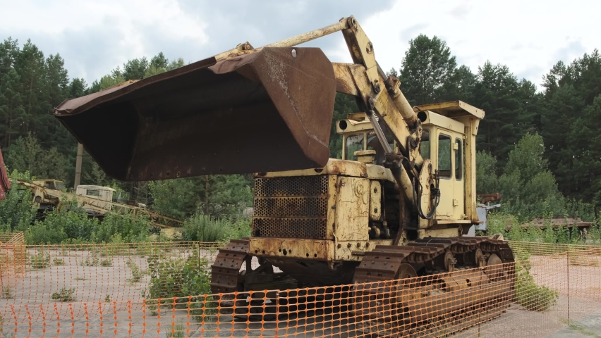 Engineering bulldozer vehicle used during liquidation of aftermath of the chernobyl disaster in Ukraine. Rusted abandoned machinery