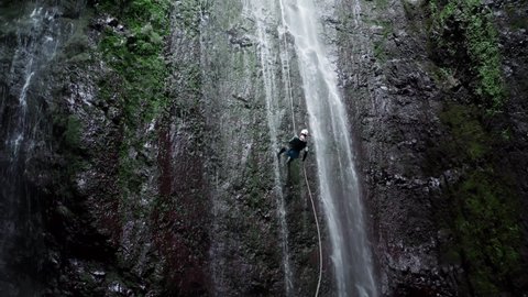 Aerial view of abseiling down a waterfall