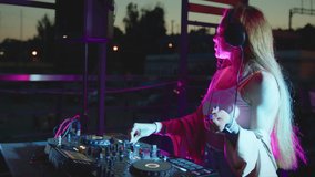 beautiful dj woman playing music at glamorous party celebration dance enjoying fancy social event wearing stylish fashion dancing performing live in club at night 4k footage.