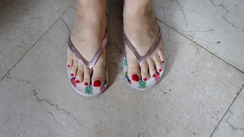 young woman's feet move their fingers to dry the newly applied nail polish