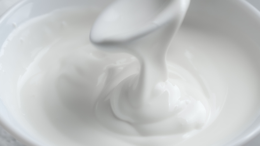 Shooting of bowl with stirred yoghurt and spoon | Shutterstock HD Video #1079130071