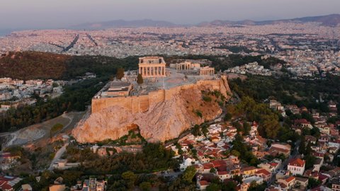 Aerial View Of Acropolis Of Athens On Rocky Outcrop Above City Of Athens In Greece At Sunrise.