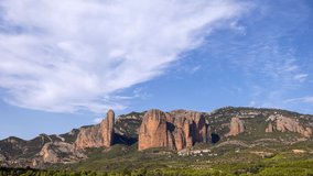 Forward and backwards looping timelapse video of los mallos de riglos in spain with the clouds moving