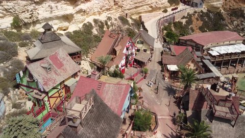 Aerial footage of Popeye Village on a sunny summer day. Beautiful drone shot of a theme park village in Malta.