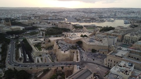 Aerial view of Valetta old city, Malta. Flying over the ancient town with many old buildings in sunset light.