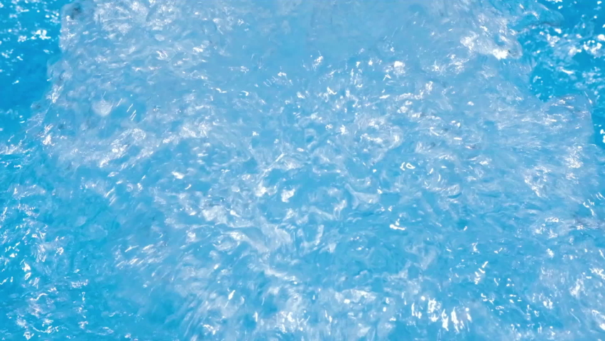 Water in hot tub. Sparkling gushing bright blue transparent water in hot tub or swimming pool. Slow motion full HD resolution video. Decorative jet or fountain of water in the hot tub. Royalty-Free Stock Footage #1079144039