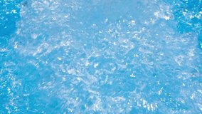 Water in hot tub. Sparkling gushing bright blue transparent water in hot tub or swimming pool. Slow motion full HD resolution video. Decorative jet or fountain of water in the hot tub.