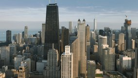 Cinematic view on golden sunset light reflecting from the skyscrapers buildings in Chicago downtown. Modern business area with glass buildings architecture with Chicago cityscape on motion background - Powered by Shutterstock - Get 15% off with code: PIKWIZARD15
