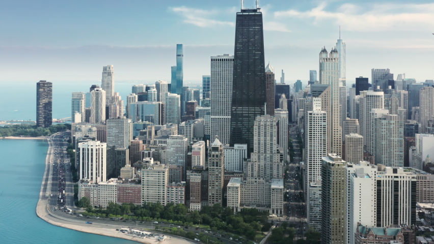 Expensive apartments in the skyscrapers with scenic Michigan lake view in Illinois, USA. 4K aerial overview of Chicago Downtown. Beautiful business and residential buildings at the frontline