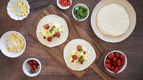 Stop Motion Animation of Making Breakfast Tacos with Scrambled Eggs and Salsa
