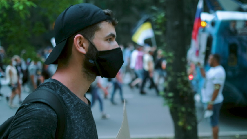 Opposition resistance protest revolt with banner placard, poster sign. Rallying strike demonstration guy in coronavirus facemask. Political crowd rebel in covid face mask. Riot activist demonstrator. Royalty-Free Stock Footage #1079156492